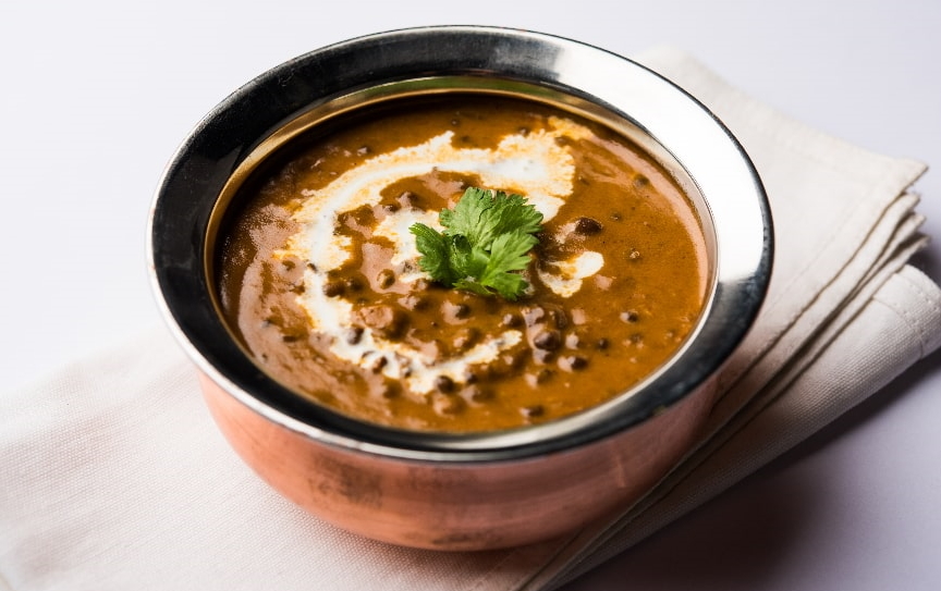 A bowl of Indian daal curry topped with coriander.